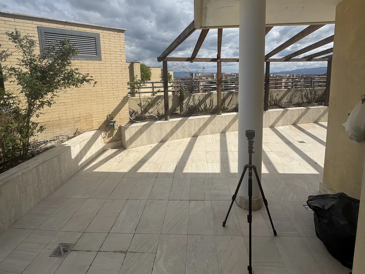 Laser scanner su treppiede durante il rilievo di un terrazzo a Roma